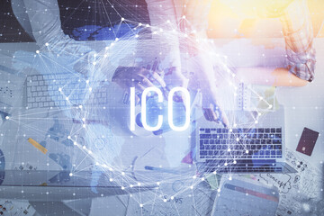 Double exposure of man and woman working together and crypto theme hologram drawing. Computer background. Blockchain concept. Top View.