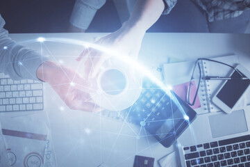 Double exposure of man and woman working together and social network theme hologram drawing. Computer background. connecting concept. Top View.