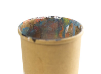 Paper cup in acrylic paints. Close up. Isolated on a white background