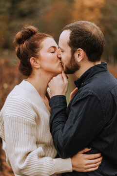Couple Sharing Romantic Kiss in Autumn Landscape