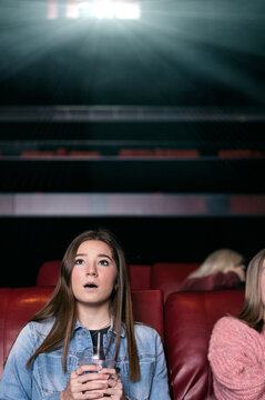 Movies: Young Woman Watching A Scary Movie In Theater
