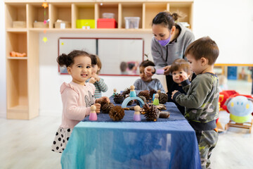 Teacher and Children playing in kindergarten