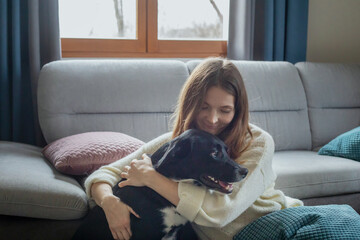 warm hugs, woman and dog sitting together at home