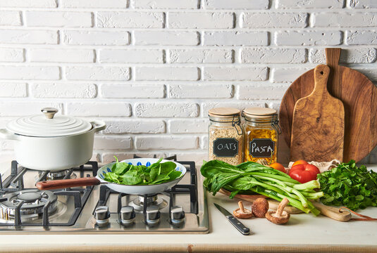Healthy Ingredients on a kitchen work surface next to a gas hob cooker.