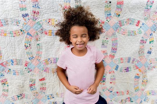 Smiling girl on quilt
