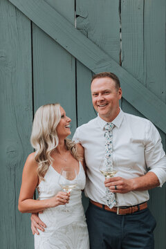 Happy Bride and Groom Drinking Wine on Wedding Day