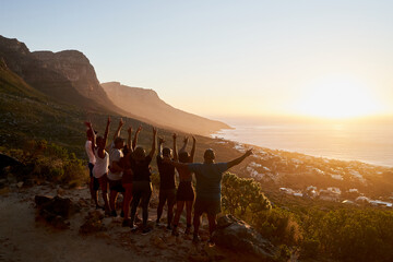 Outdoor friends with hands and arms in the air