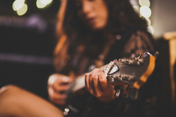 Asian woman  studying music at home.