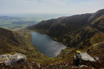 Naklejka na ściany i meble lake from a glacier buried in a mountainous valley. Comeragh Mountains, Waterford, Ireland