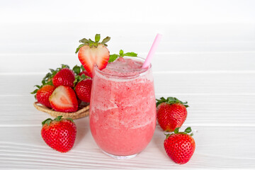 Strawberry yogurt fruit juice smoothie pink colorful fruit juice milkshake blend beverage healthy high protein the taste yummy In glass drink episode morning on white wood background.