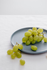 Green grapes in a blue dish on the table