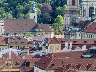 Prague cityscape - shot taken from Prague castle towards Petrin hill, overlooking roof tops and part of St Nicholas cathedral