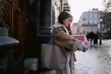 Stylish girl holding huge pink box 