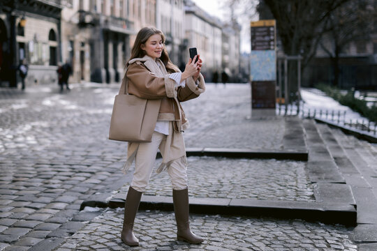 Woman taking selfie on ancient street