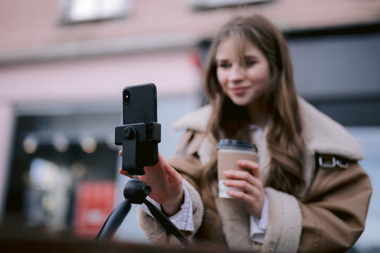 Blogger taking selfie outside 