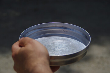 Empty bowl in hand as concept of global famine and hunger crisis