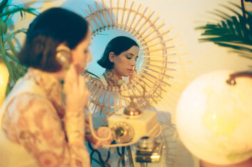 70s Woman calling with vintage telephone