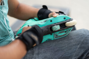 person repairing inline skates damaged by time of use