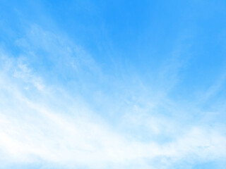 Blue sky background with tiny clouds.