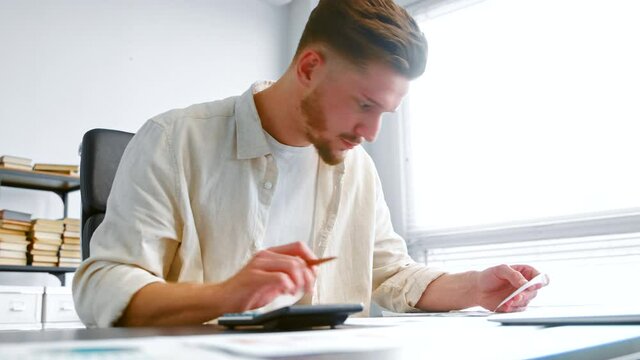 Professional bank accountant summarizes total on calculator