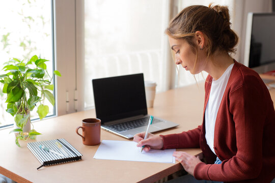 Student girl doing homework in her home