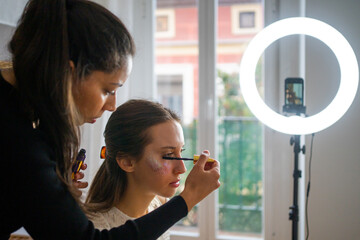Two Youtuber Influencers Putting On Makeup.