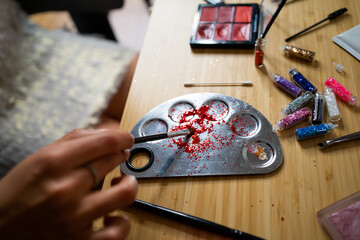 Palette With Glitter Make Up On The Table.