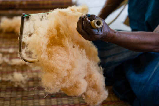The old woman fluffing cotton