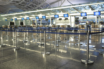 Coronavirus outbreak, empty check-in desks at the airport terminal due to pandemic of coronavirus an
