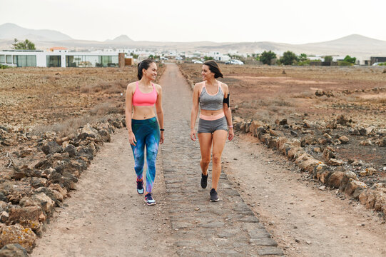 Fit Friends Walking On A Rock Trail