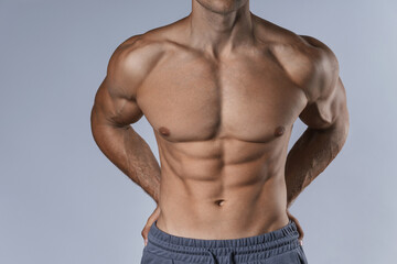 Muscular male torso against gray background