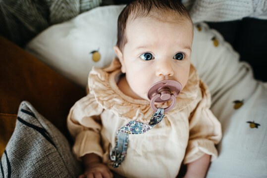 Close up of a new born baby girl with pacifier