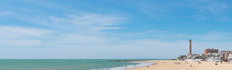 Chipiona beach with the Lighthouse in the background (the highest in Spain and the fifth in the world) in the province of Cadiz. Andalusia. Spain. Europe.
