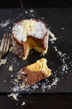 Chocolate mousse cake with mango cream and coconut flakes