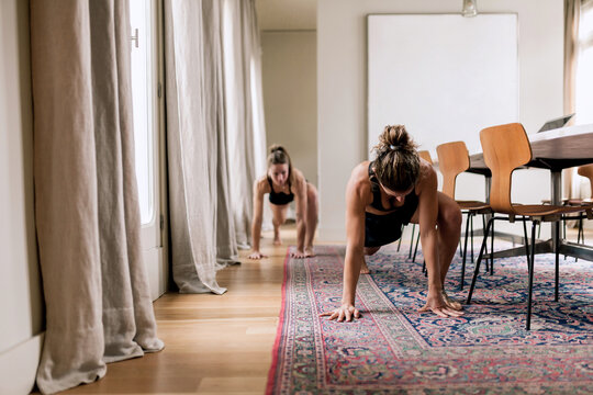 Trainer showing yoga exercise to woman