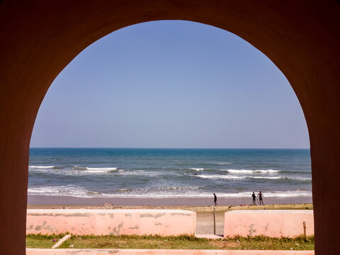 An arch at the ancient Danish fort of Fort Dansborg with a view of the sea in the town of Tranquebar.