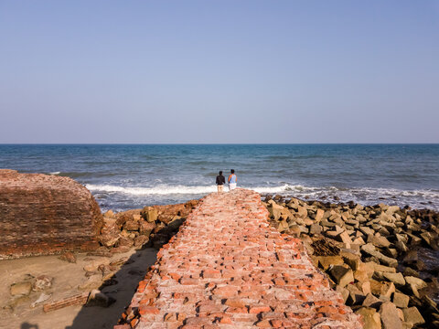 The ruins of ancient brick walls of Fort Dansborg leading to the sea in the ancient Danish colony of Tranquebar.