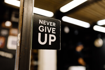 lettering "Never give up"