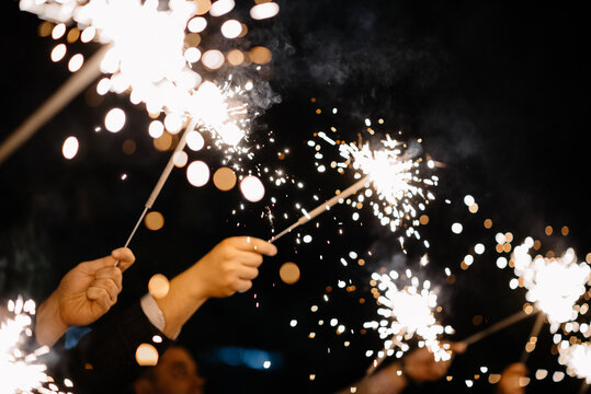 Unrecognizable people holding Sparkler in hand