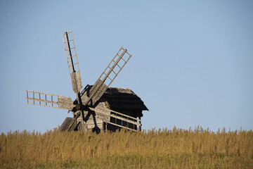 Fototapeta premium Vintage windmill wooden mill with wind wheel blades.