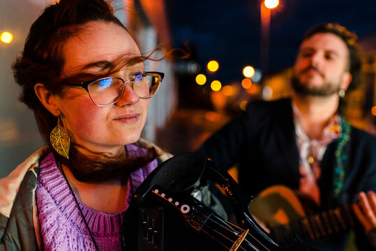 Gen z musicians playing musical equipment on street