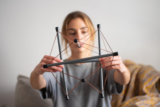 Teenager holding a tensegrity model