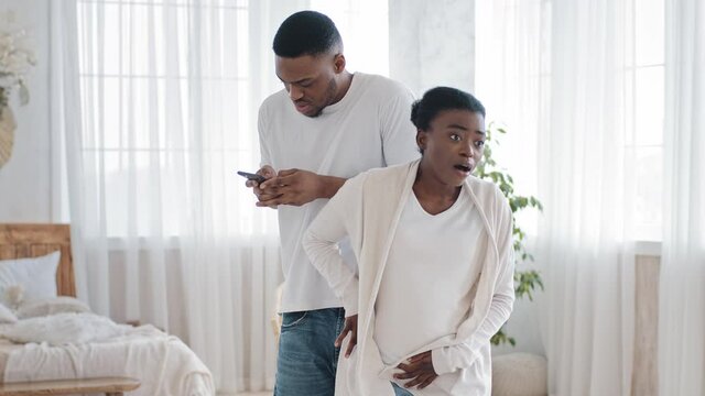 Pregnant african american woman black ethnic expectant mommy future mother feeling contraction spasm tummy pain screaming in discomfort afro man caring husband supporting wife calls hospital clinic