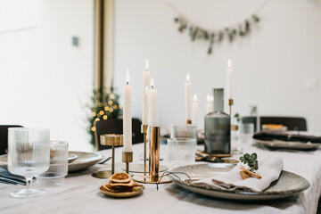 Candles on a festive dinner table with day light