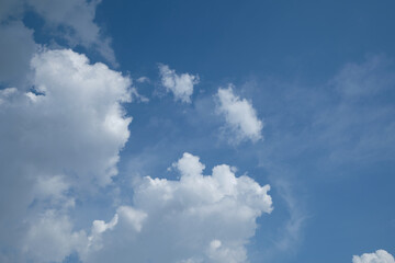 White clouds over blue sky horizontal with copyspace