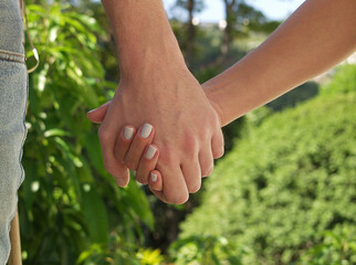 Couple in love holding hands detail.