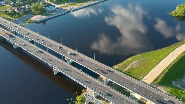 Cars traffic on bridge over the river in city, aerial view. Top view of bridge over Sozh river in Gomel, Belarus. Birds eye view cityscape