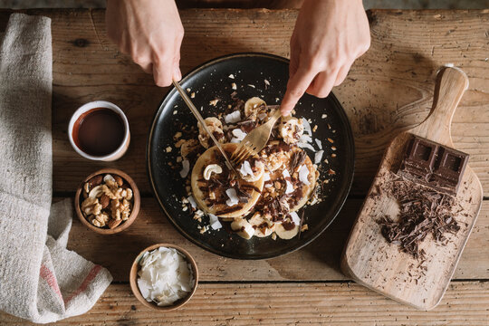 Anonymous Woman Cutting Homemade Organic Pancakes From Above