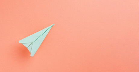 Flat lay of Paper Plane over pastel background with copyspace use for travel,holiday concept.