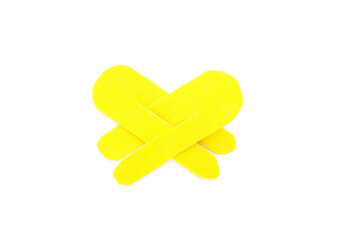Yellow kinesio tape pieces on white background, top view
